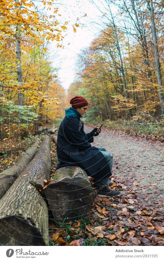 Man posing in autumnal wood Street PDA using browsing texting Youth (Young adults) Town Lifestyle Easygoing Fashion Style warm clothes Adults Modern Human being