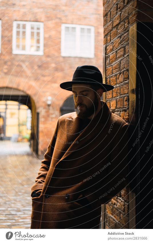 Stylish man leaning on wall Man handsome City Coat Hat Lean Street Youth (Young adults) Town Lifestyle Easygoing Fashion Style Adults Modern Human being