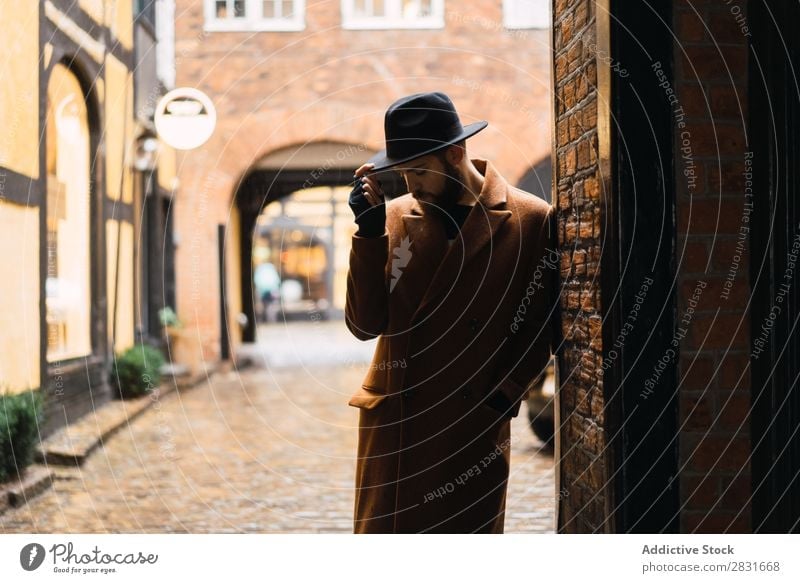 Stylish man leaning on wall Man handsome City Coat Hat Lean Street Youth (Young adults) Town Lifestyle Easygoing Fashion Style Adults Modern Human being