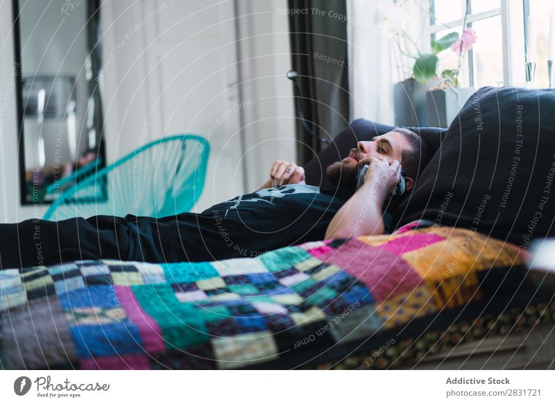 Man lying and talking on phone handsome Home Lie (Untruth) PDA To talk Bed Communication Youth (Young adults) Portrait photograph Lifestyle Human being