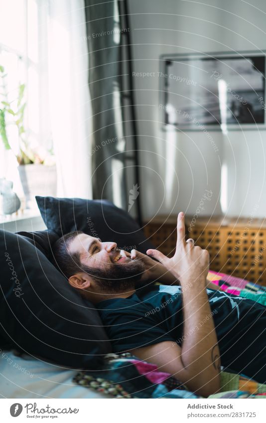 Man lying and talking on phone handsome Home Lie (Untruth) PDA To talk Bed Communication Youth (Young adults) Portrait photograph Lifestyle Human being