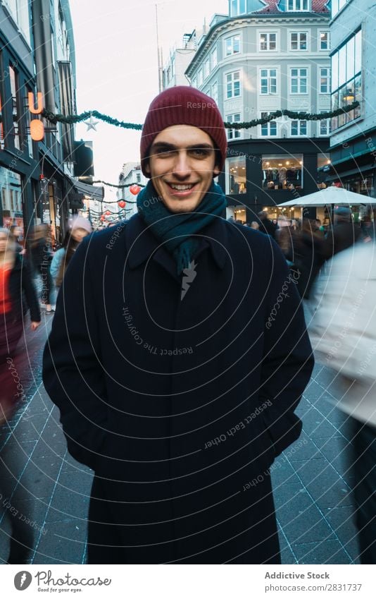 Cheerful man on crowded street Man Smiling Stand Portrait photograph Looking into the camera warm clothes Crowded handsome City Street Youth (Young adults) Town