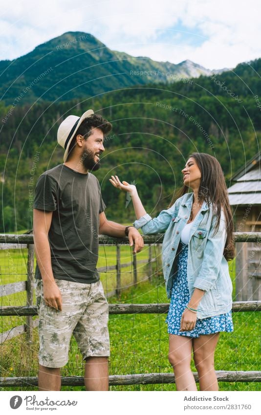 Couple speaking on meadow Hat Hill Nature Summer Human being Man Woman Love Grass Beautiful Together Youth (Young adults) Happy Landscape Vacation & Travel