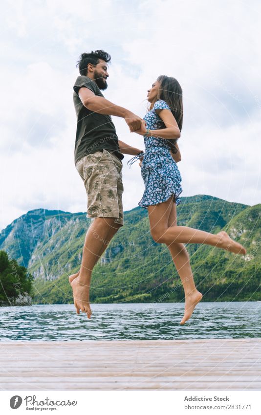 Couple jumping on pier Jetty Joy Lake Mountain Jump Happy Love Together Nature Summer Water Youth (Young adults) Woman Vacation & Travel Lifestyle Human being