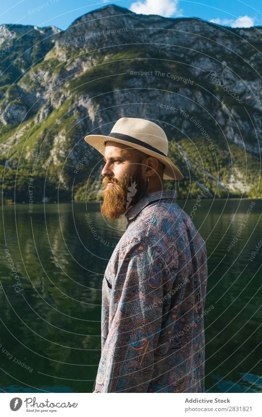 Bearded man standing at lake Man Lake Stand Mountain bearded Water Nature Landscape Human being Tourism Hiking Loneliness Calm Tourist Rock scenery Relaxation