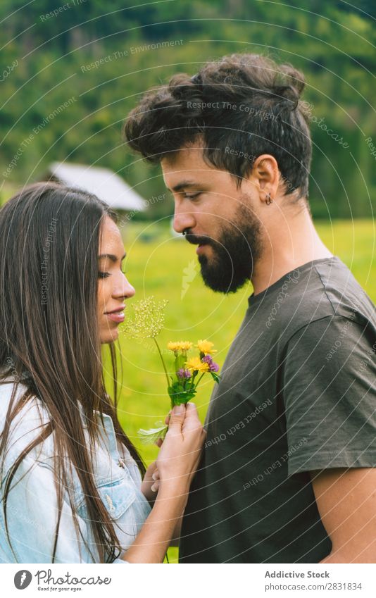 Couple cuddling on meadow Meadow Hill Cuddling Flower bunch Small Nature Summer Human being Man Woman Love Grass Beautiful Together Youth (Young adults) Happy