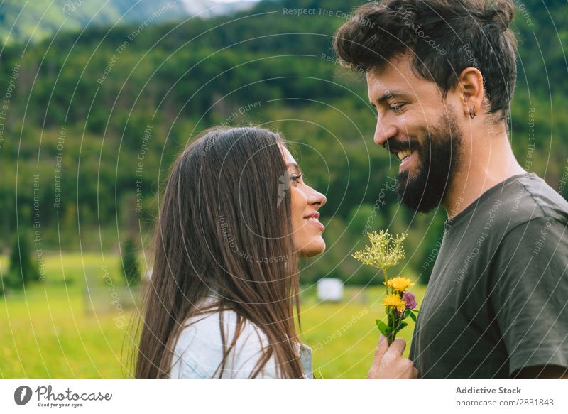 Couple cuddling on meadow Meadow Hill Cuddling Flower bunch Small Nature Summer Human being Man Woman Love Grass Beautiful Together Youth (Young adults) Happy