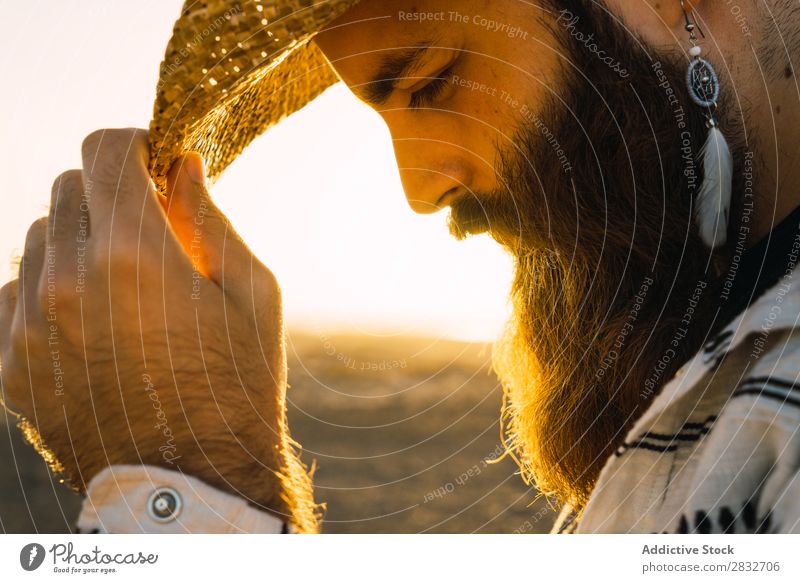 Bearded man in hat against sunlight Man bearded Cowboy Style Sunlight Self-confident Nature Portrait photograph Hat Countries Masculine Earnest Straw hat outfit