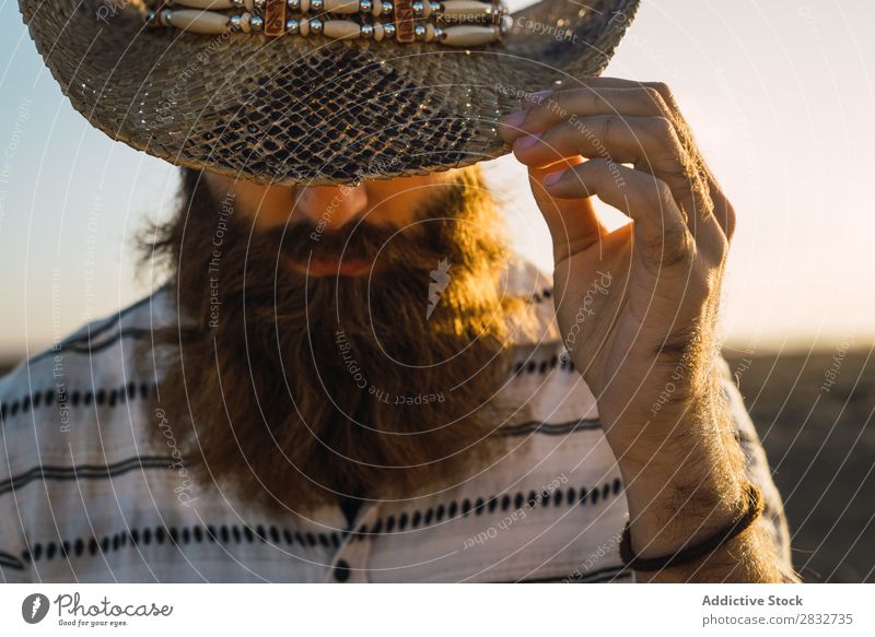 Bearded man in hat against sunlight Man bearded Cowboy Style Sunlight Self-confident Nature Portrait photograph Hat Countries Masculine Earnest Straw hat outfit