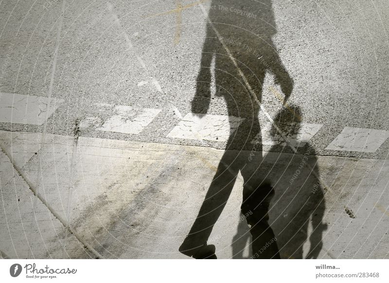 Feeling left out - shadow of two people on the street Shadow Pedestrian Pedestrian crossing Identity Shadow play Dark side Shadowy existence Tracks Ignore Going