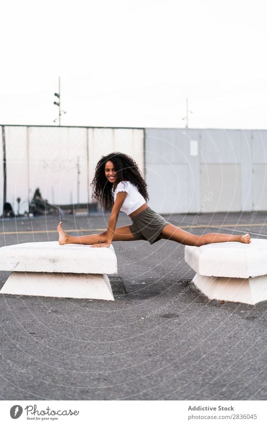 Happy woman doing string Woman pretty Youth (Young adults) String Sit Gymnastics City Town Concrete blocks Smiling Cheerful Portrait photograph