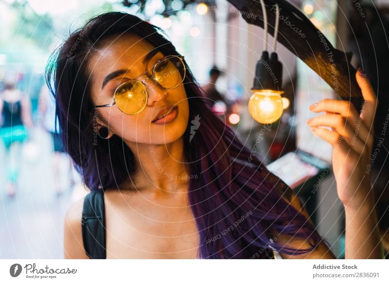 Pretty Asian woman watching lamp Woman pretty Street Youth (Young adults) Beautiful Portrait photograph Touch Bulb Tree Lighting Hair Purple asian eastern
