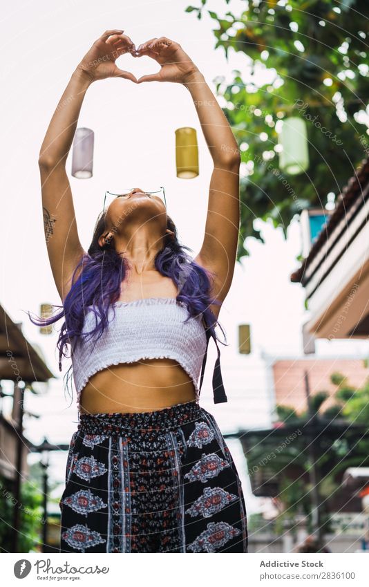 Woman gesturing on street pretty Street Youth (Young adults) Beautiful Heart Hands up! shoving Love Symbols and metaphors Portrait photograph Hair Purple asian