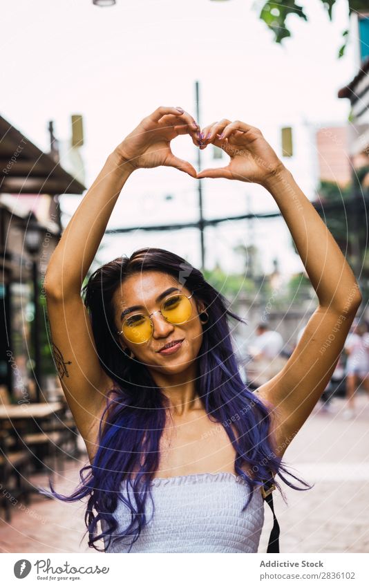 Woman gesturing heart on street pretty Street Youth (Young adults) Beautiful Heart Hands up! shoving Love Symbols and metaphors Portrait photograph Hair Purple