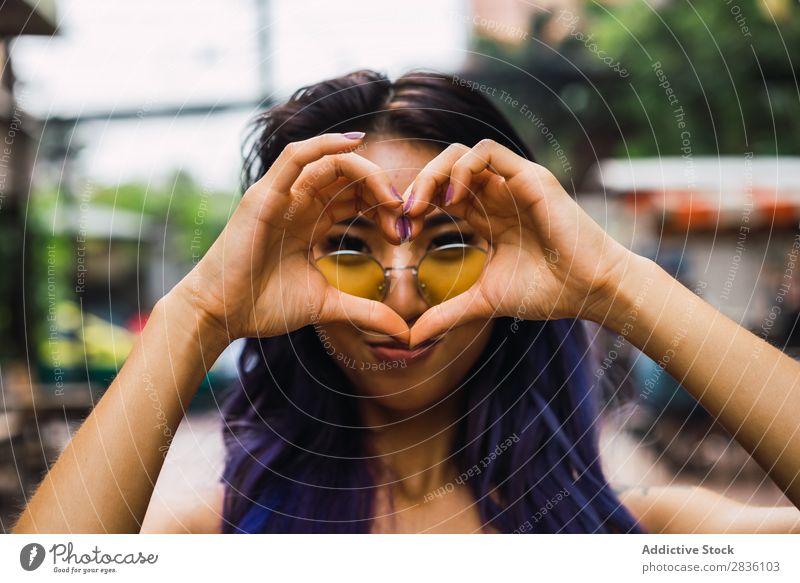 Woman gesturing heart on street pretty Street Youth (Young adults) Beautiful Heart Hands up! shoving Love Symbols and metaphors Portrait photograph Hair Purple