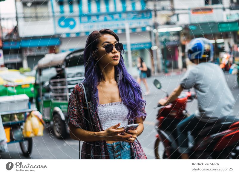 Asian woman with phone on street Woman pretty Street Youth (Young adults) Beautiful PDA Gadget device Sunglasses Portrait photograph Hair Purple asian eastern