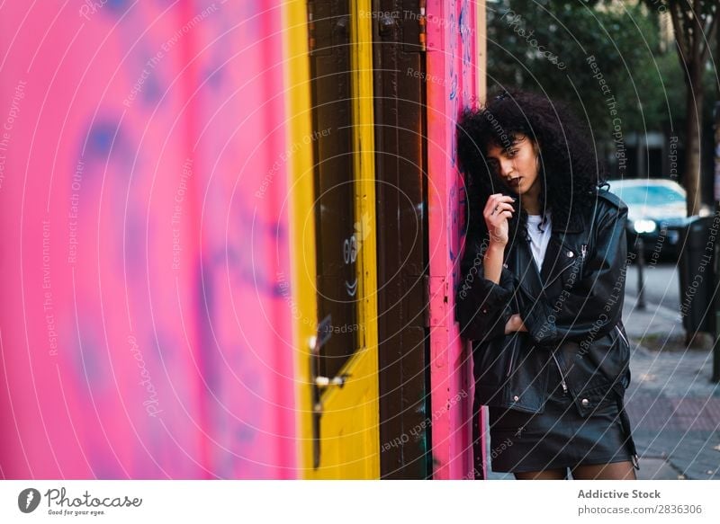 Glamour woman at pink wall Woman Attractive City fashionable Curly Wall (building) Pink Lean Brunette Jacket Fashion Youth (Young adults) Beautiful pretty