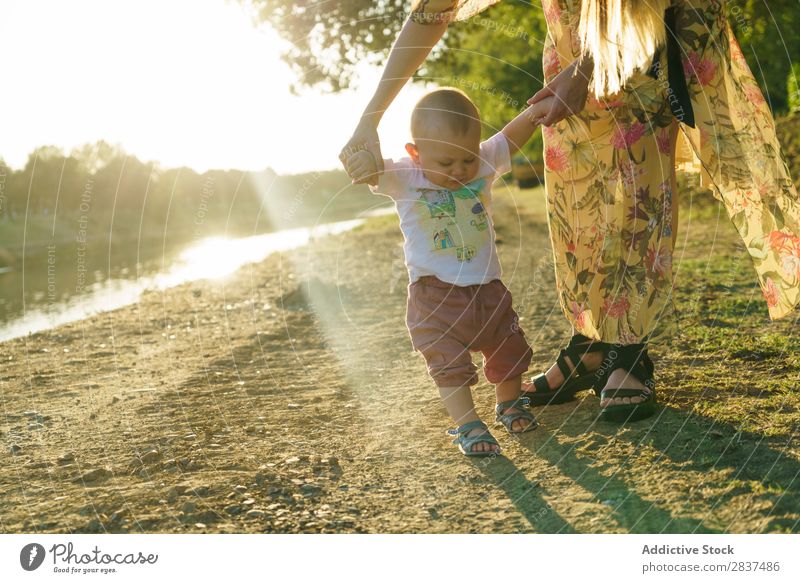 Mother holding walking child Child Park stepping School Walking Support Sunbeam Family & Relations Happy Human being Woman Happiness Summer Lifestyle Love