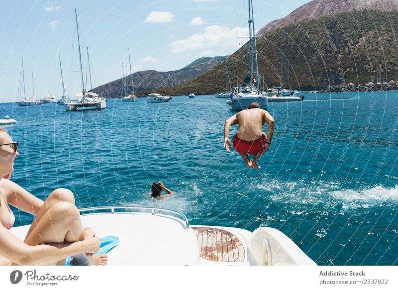 Man jumping from yacht Woman Yacht Jump Swimming Transport Athletic amusement Freedom Sailboat Ocean romantic Swimmer (professional sportsman) Relaxation Summer