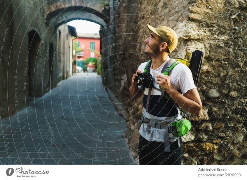Content traveler enjoying city Man backpacker Street photo camera Old Sightseeing Summer Vacation & Travel Appearance Town Tourist Ancient Vantage point