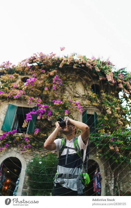Man taking photo of surroundings in city backpacker Tourist Town Memory romantic Photographer Camera Street Traveling City Lifestyle Technology Easygoing