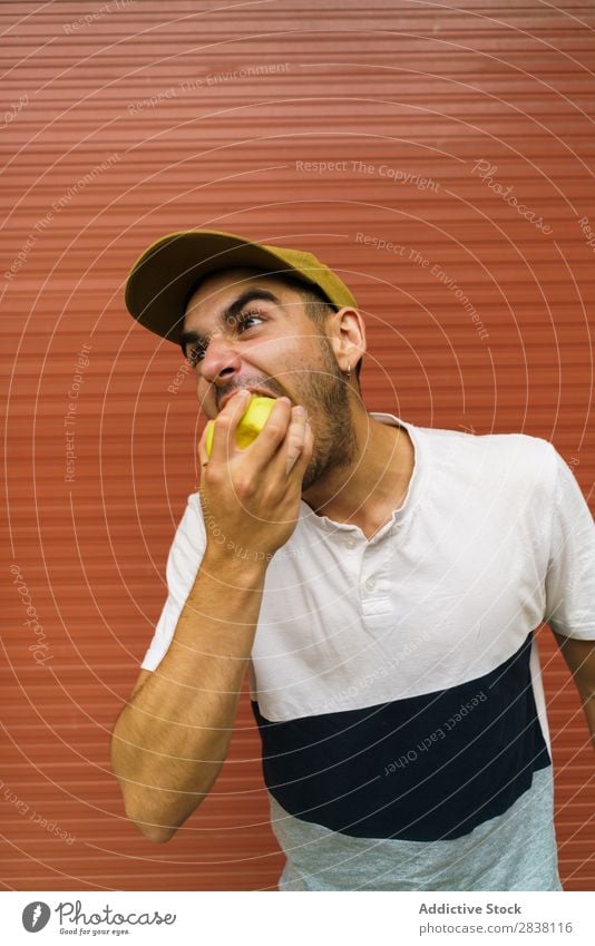 Man Eating Apple Near Wall A Royalty Free Stock Photo From Photocase