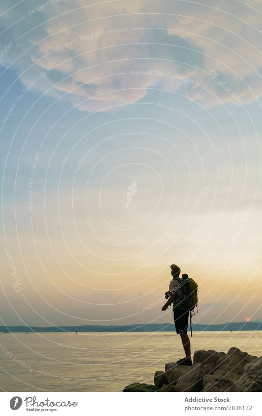 Backpacker posing on rocks Man traveler Posture Action Rock Summer Youth (Young adults) Adventure Ocean Landscape City backpacker pretend Funny Sports Trip