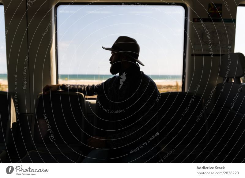 Silhouette of man in train Man Ride Railroad Hat Beard Vacation & Travel Transport Human being Passenger Trip traveler Seat wagon Sit Vehicle Speed Tourist