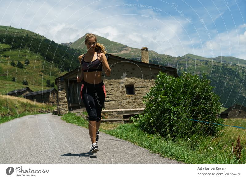 Woman jogging in countryside Street Jogging Rural Athletic Youth (Young adults) Fitness Practice Athlete Sports Landscape workout Leisure and hobbies Action