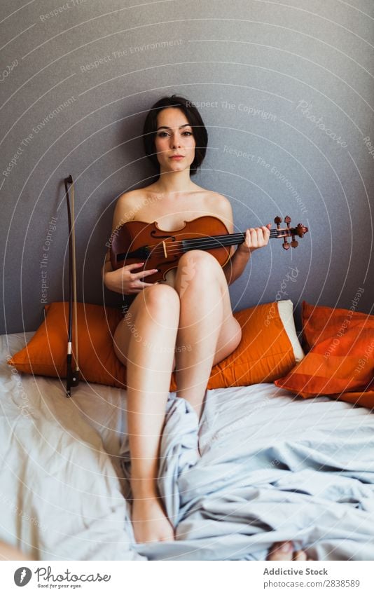 Naked woman posing with violin - a Royalty Free Stock Photo from Photocase