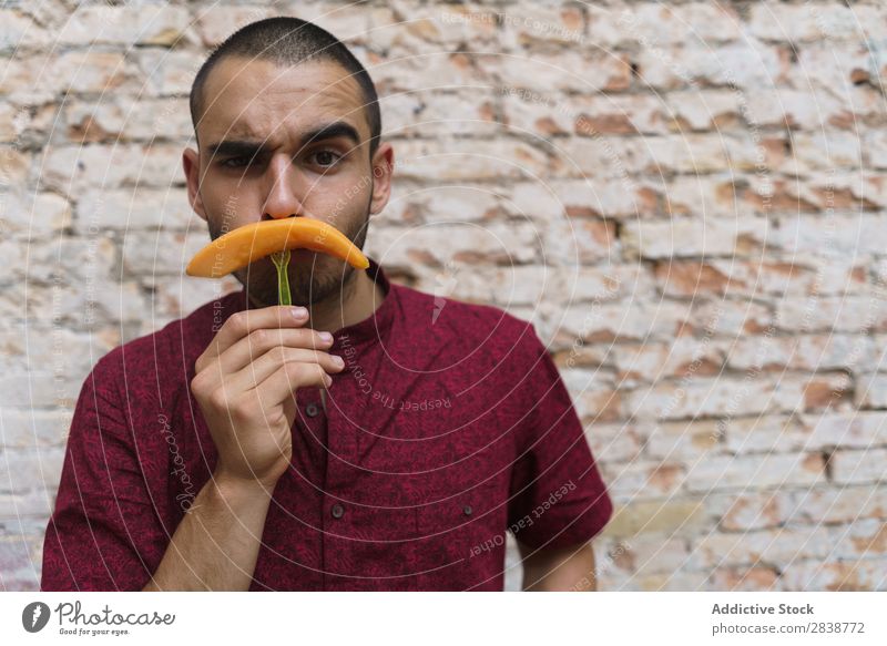 Playful man posing with fruit Man pretend Moustache having fun Fruit Replication Posture Melon Comic Humor Street Joke Youth (Young adults) Slice Grimace Joy