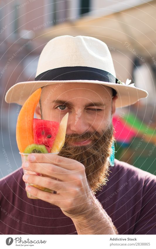 Smiling man with glass of fruits Man traveler Fruit Fresh Summer Tourist Exotic Refreshment Tropical Hold Healthy Markets Indicate tropic Youth (Young adults)
