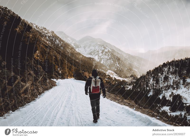 Tourist with backpack walking in mountains Human being Backpack Winter Hill Mountain Snow Landscape Nature White Ice Seasons Cold Vacation & Travel way Frost
