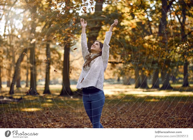 Joyful young woman throwing autumn leaves Happy Beautiful Woman Adults Family & Relations 1 Human being 18 - 30 years Youth (Young adults) Nature Autumn Tree