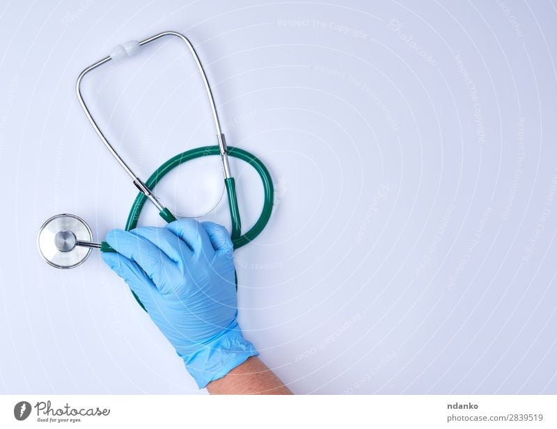Doctor's hands in medical gloves in shape of heart on blue