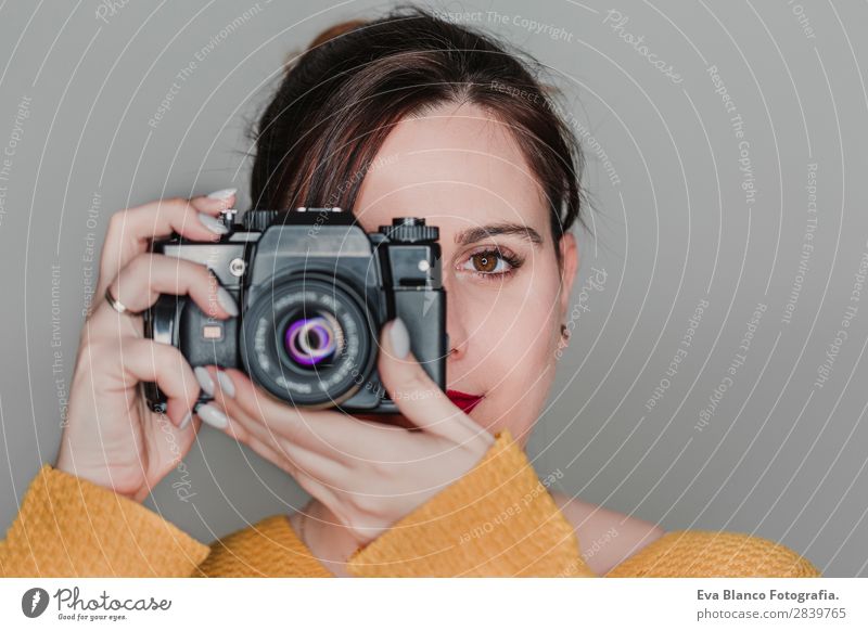 close up portrait of a young woman holding a camera Lifestyle Happy Beautiful Face Leisure and hobbies Work and employment Camera Human being Woman Adults Art