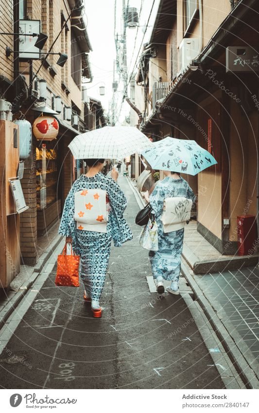 Women in Asian traditional clothes Woman Tradition Clothing Umbrella Walking Together House (Residential Structure) Wood asian Home Japanese Architecture