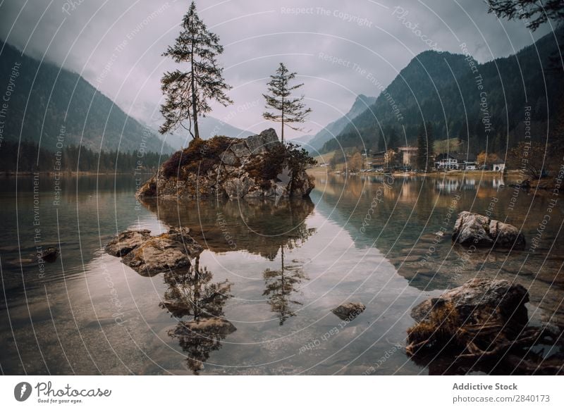 Rocks with trees in lake Mountain Lake Tree Island Landscape Reflection scenery Panorama (Format) Tourism tranquil Adventure Peaceful Valley Natural Wilderness