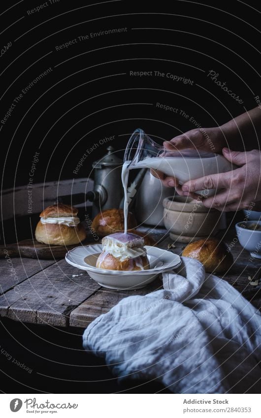 Hands pouring milk on bun Sweet Baked goods Rustic Delicious Milk Roll Cream Portion Dessert Food Fresh Tasty Home-made Gourmet Bakery Snack Breakfast Healthy