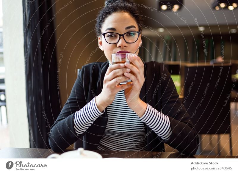 Beautiful young woman drinking tea in coffee. Drinking Tea Woman indoor Café Table Attractive Sit Coffee Beverage Brunch Break Adults Cup Breakfast To enjoy