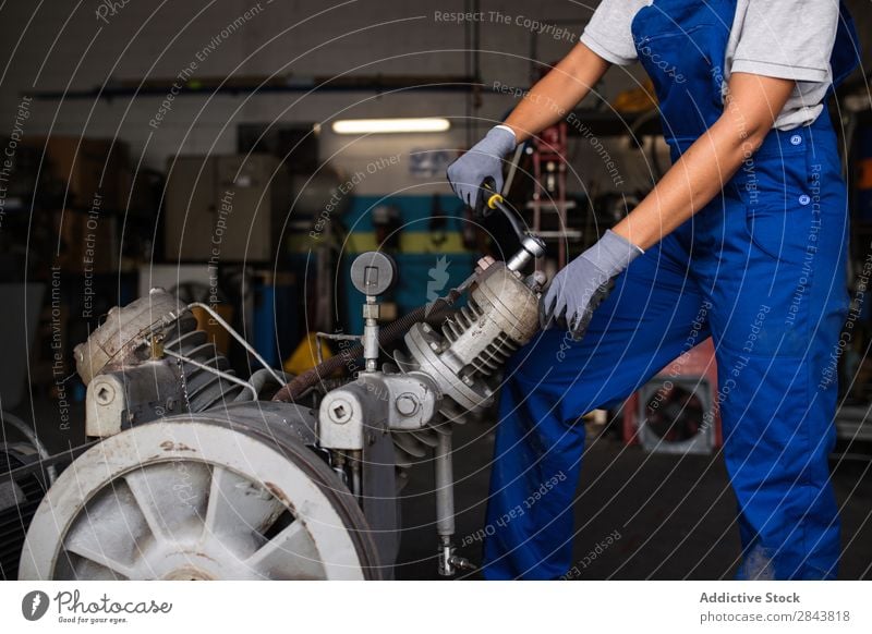 female mechanic fixing a compressor enginge using a wrench Mechanic Woman Portrait photograph Repair Employees &amp; Colleagues Industrial Engines Technology