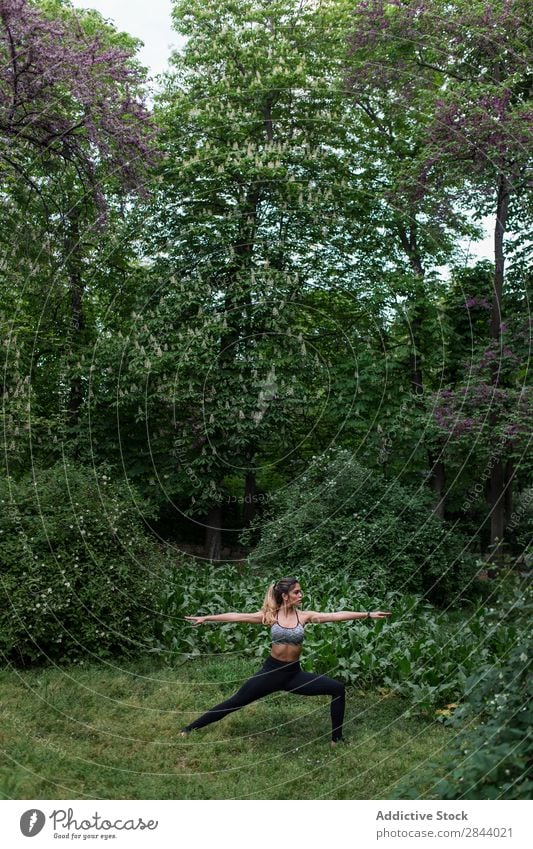 Beautiful woman meditating in park Woman Yoga Nature Park Relaxation Balance Healthy Concentrate Green Fitness Stand Body Exterior shot Wellness Lifestyle