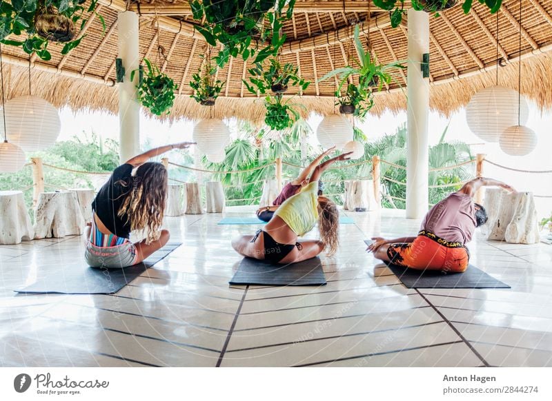 Group of young people practice yoga class at surf camp in Bali Lifestyle Healthy Athletic Fitness Wellness Meditation Vacation & Travel Summer Island Yoga