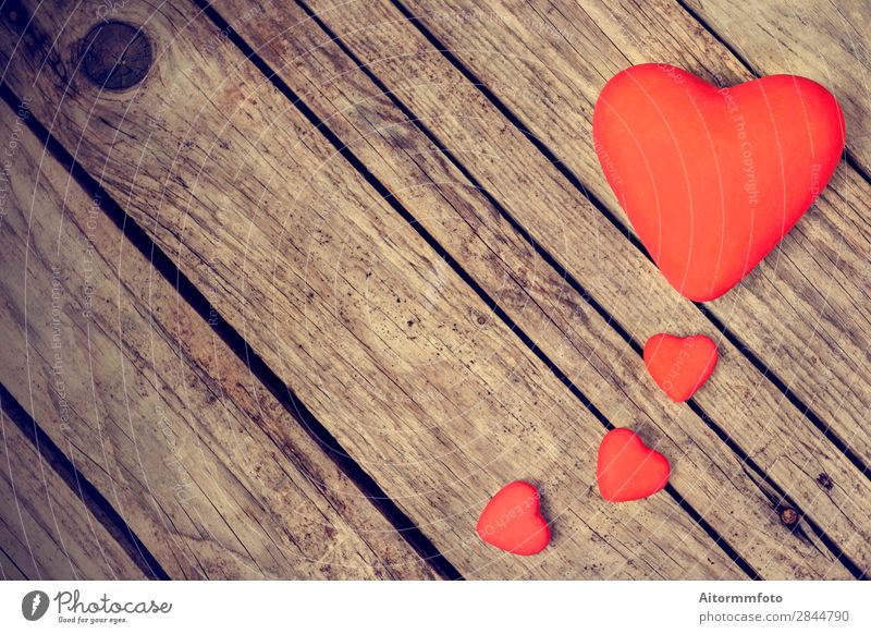 two red ceramic hearts on love letter paper background - a Royalty Free  Stock Photo from Photocase