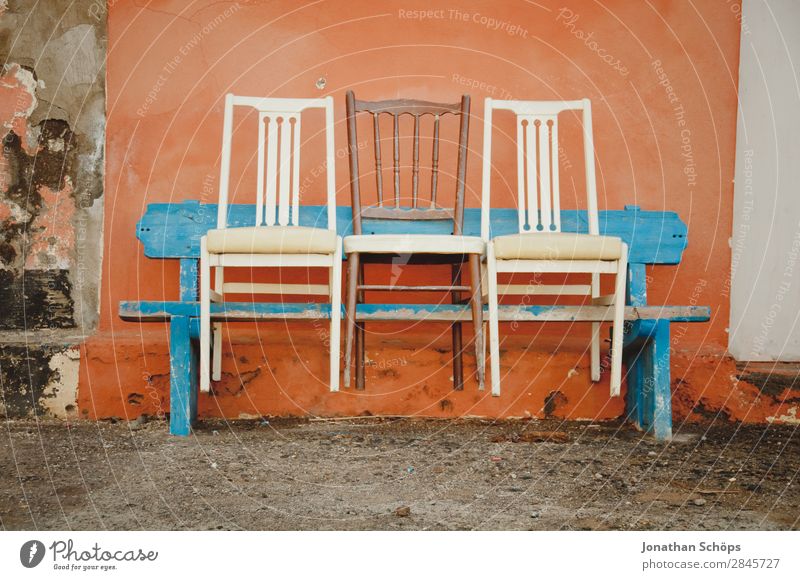 Three chairs on a bench, Puerto de la Cruz, Tenerife Facade Blue Orange White Colour Bench Chair Row of seats Row of chairs 3 Wall (building) Spain Canaries