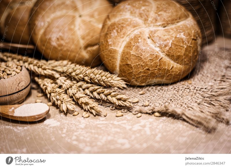 Freshly baked bread, wheat and flour on a rustic background Food Dough Baked goods Bread Nutrition Eating Breakfast Lunch Dinner Buffet Brunch Table Kitchen