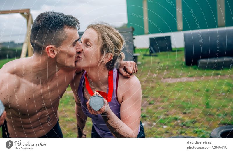Couple kissing and showing medals after race Happy Playing Feasts & Celebrations Sports Award ceremony Success Human being Woman Adults Man Kissing Love