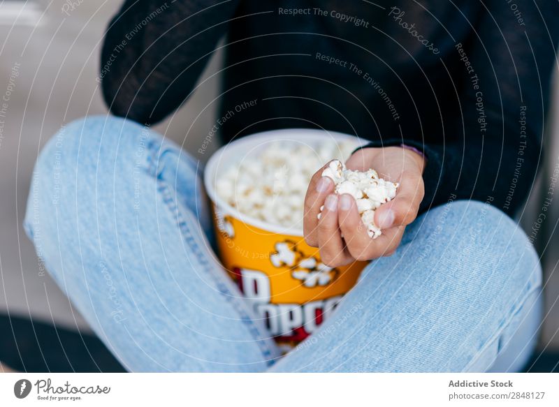 Crop girl with popcorn in hand Woman Popcorn Town Accumulation Youth (Young adults) Snack Style Hold Clothing Hipster Sit Bucket Culture Independence Posture