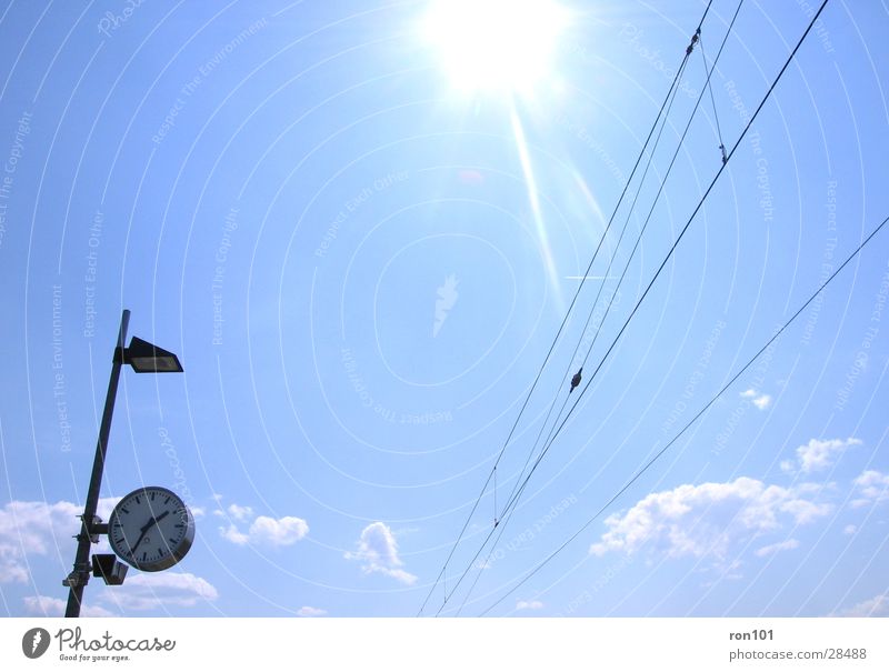 13:34 Clock Transmission lines Lamp Time Clouds Transport Sky Sun Cable Blue Station