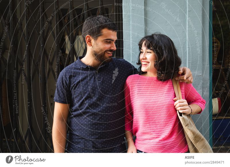 Happy young couple smiling at each other Lifestyle Shopping Joy Beautiful Summer Woman Adults Man Friendship Couple Street T-shirt Sweater Brunette Beard